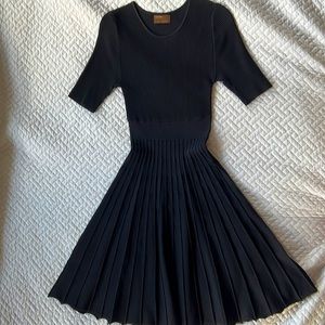 Pretty scalloped edge ribbed sweater dress. Fit flare style with pleated skirt.